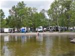 Travel trailers in a row at water view sites at GLENROCK COTTAGES & TRAILER PARK - thumbnail