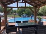 View larger image of Looking at the swimming pool from a gazebo at CAMPING DU VIEUX MOULIN image #2