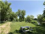View larger image of Picnic benches on grassy RV sites at CAMPING DU VIEUX MOULIN image #4