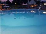 View larger image of The swimming pool at dusk at CAMPING DU VIEUX MOULIN image #10