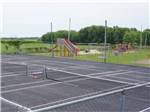 View larger image of The pickleball court and playground at CAMPING DU VIEUX MOULIN image #12