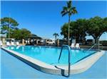 View larger image of The pool area with chairs at PALM VIEW GARDENS RV RESORT image #1