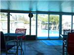 View larger image of Inside the clubhouse looking out at the pool at PALM VIEW GARDENS RV RESORT image #9