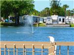 View larger image of The lake with a fountain in the middle at SUNDANCE LAKES RV RESORT image #4