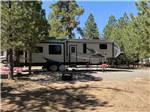View larger image of A fifth wheel trailer in a RV site next to trees at BRYCE CANYON PINES STORE  CAMPGROUND  RV PARK image #4