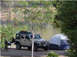 View larger image of A Jeep with a tent along the water at SANTEE LAKES RECREATION PRESERVE image #11