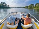 View larger image of Two people driving a boat down the river at DELAWARE RIVER FAMILY CAMPGROUND image #1