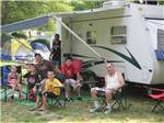 View larger image of Family in campsite in front of motorhome at DELAWARE RIVER FAMILY CAMPGROUND image #3