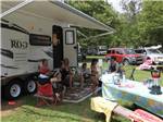View larger image of Campers gather under awning of RV at DELAWARE RIVER FAMILY CAMPGROUND image #6