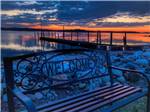 A park bench facing away from the water at SEAVIEW CAMPGROUND & COTTAGES - thumbnail