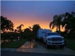 A truck and trailer in a back in RV site at dark at BAY BAYOU RV RESORT - thumbnail