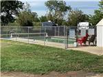 The fenced in swimming pool at BIG SKY CAMP & RV PARK - thumbnail