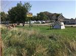 A windmill next to the park sign at BIG SKY CAMP & RV PARK - thumbnail