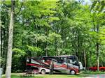 A black and red motorhome in a RV site at HIDDEN HILL FAMILY CAMPGROUND - thumbnail