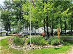 An area with flowers and the American flag at HIDDEN HILL FAMILY CAMPGROUND - thumbnail