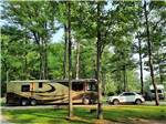 A motorhome and car in a pull thru site at HIDDEN HILL FAMILY CAMPGROUND - thumbnail