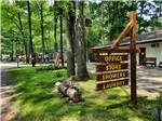 A wooden directional sign at HIDDEN HILL FAMILY CAMPGROUND - thumbnail