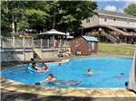 Kids swimming in the swimming pool at KATAHDIN SHADOWS CAMPGROUND & CABINS - thumbnail