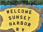 View larger image of A yellow sign of the campground at SUNSET HARBOR RV PARK image #8