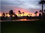 View larger image of The pond and fountain at sunset at WESTWIND RV  GOLF RESORT image #1