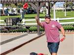 Man playing corn hole at Westwind RV & Golf Resort - thumbnail