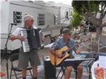 A couple of gentlemen playing musical instruments at SHANGRI-LA RV RESORT - thumbnail