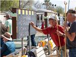 View larger image of A few men standing around playing shuffleboard at TROPHY GARDENS image #9