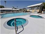 View larger image of The hot tubs and swimming pool at TROPHY GARDENS image #11