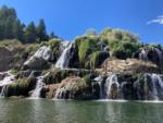 A mountain with beautiful waterfalls nearby at SWAN VALLEY RV PARK - thumbnail