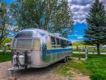 An Airstream trailer parked in a gravel site at SWAN VALLEY RV PARK - thumbnail
