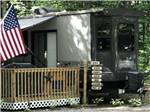 An RV with an American flag parked at SARATOGA RV PARK - thumbnail