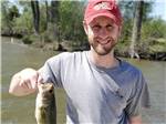 A man holding up a fish he caught at CAMELOT CAMPGROUND QUAD CITIES - thumbnail