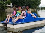 A family in a paddle boat at CAMELOT CAMPGROUND QUAD CITIES - thumbnail