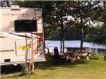 View larger image of A motorhome parked next to the water at TWO RIVERS CAMPGROUND image #2