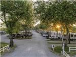 Looking down the road to the sites full of RVs and trailers at RIVERSIDE RV PARK & RESORT - thumbnail