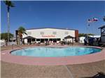 View larger image of The kidney shaped swimming pool at WINTER RANCH RV RESORT image #10