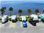 View larger image of A row of back in RV sites next to the water at EMERALD BEACH RV PARK image #12