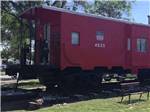 View larger image of Kids standing on the red caboose at BANDERA PIONEER RV RIVER RESORT image #2