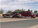 Big diesel motorhome with trailer in a pull-through site at OK RV PARK - thumbnail