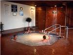 View larger image of People in indoor hot tub with brown tile flooring at BURNABY CARIBOO RV PARK image #9