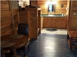 View larger image of Bathroom counter with light in wooden cabin at WANDERLUST RV PARK image #4