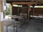 View larger image of Canopy covering tables and stone oven at WANDERLUST RV PARK image #9