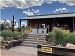 Brick stairs lead to office with cacti and desert plants at ROYAL VIEW RV PARK - thumbnail