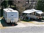 A row of occupied gravel RV sites at HIGH SIERRA RV & MOBILE PARK - thumbnail