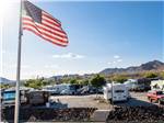 View larger image of An American flag flying over the campsites at CANYON TRAIL RV PARK image #6