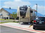 View larger image of A fifth wheel trailer in a paved RV site at ROADRUNNER RV PARK image #6