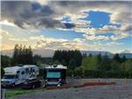 Cars and RVs on-site at dawn at MT ST HELENS RV PARK - thumbnail