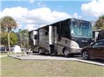 View larger image of A Class A motorhome in a paved site at RAINBOW CHASE RV RESORT image #3
