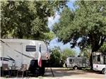 A fifth wheel trailer with flags on it at SCHULENBURG RV PARK - thumbnail