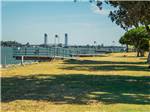 A view of the docks and grassy area at DUCK ISLAND RV PARK & FISHING RESORT - thumbnail